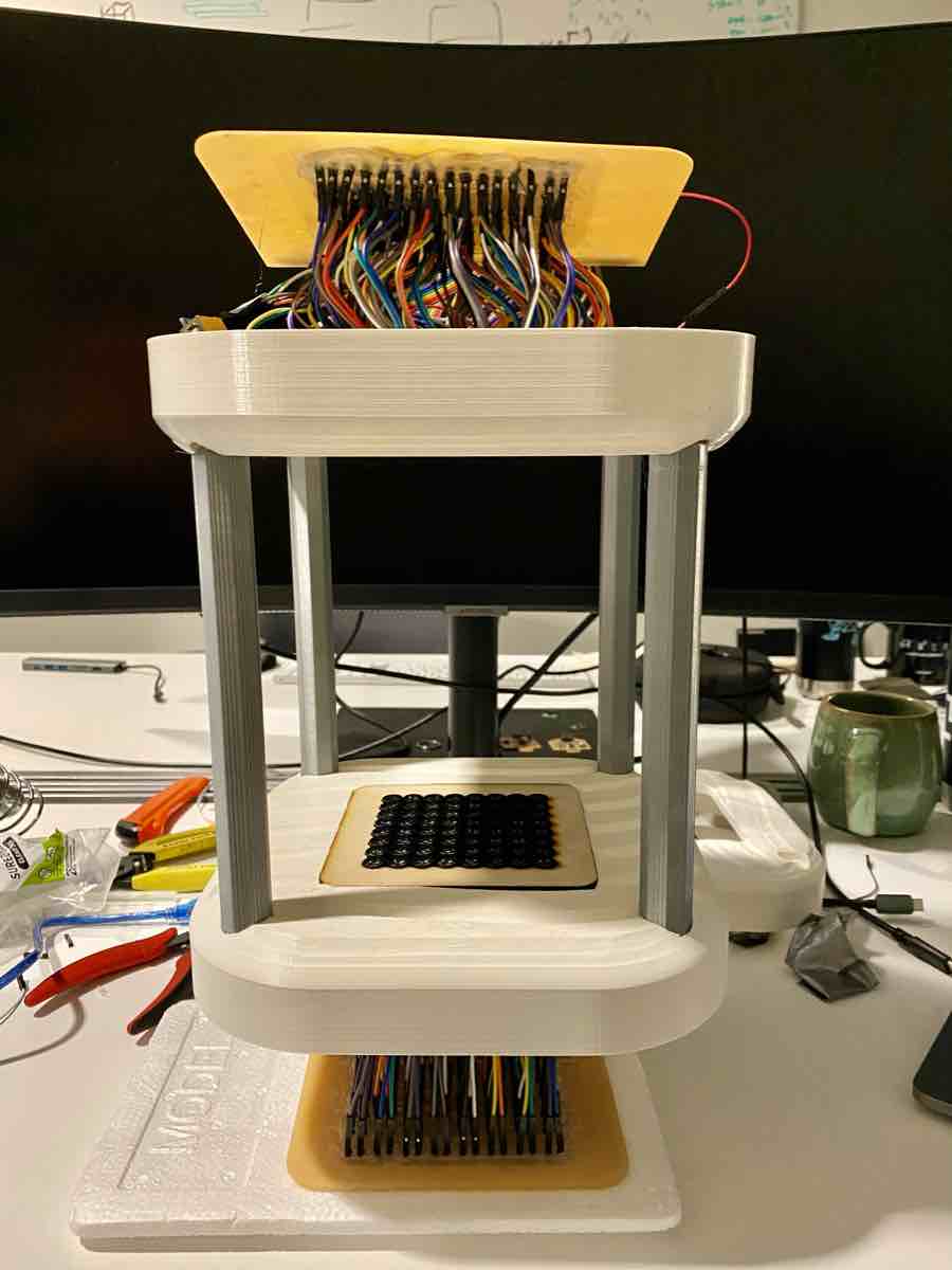Fully assembled device with both transducer arrays, wiring harness, and enclosure on the workbench