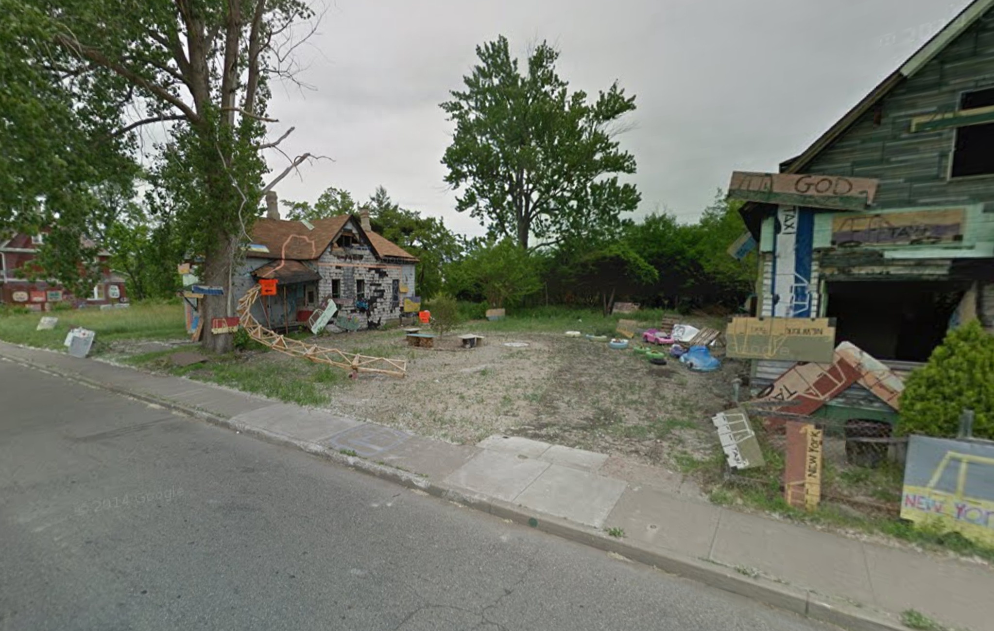 The empty lot between the two remaining houses