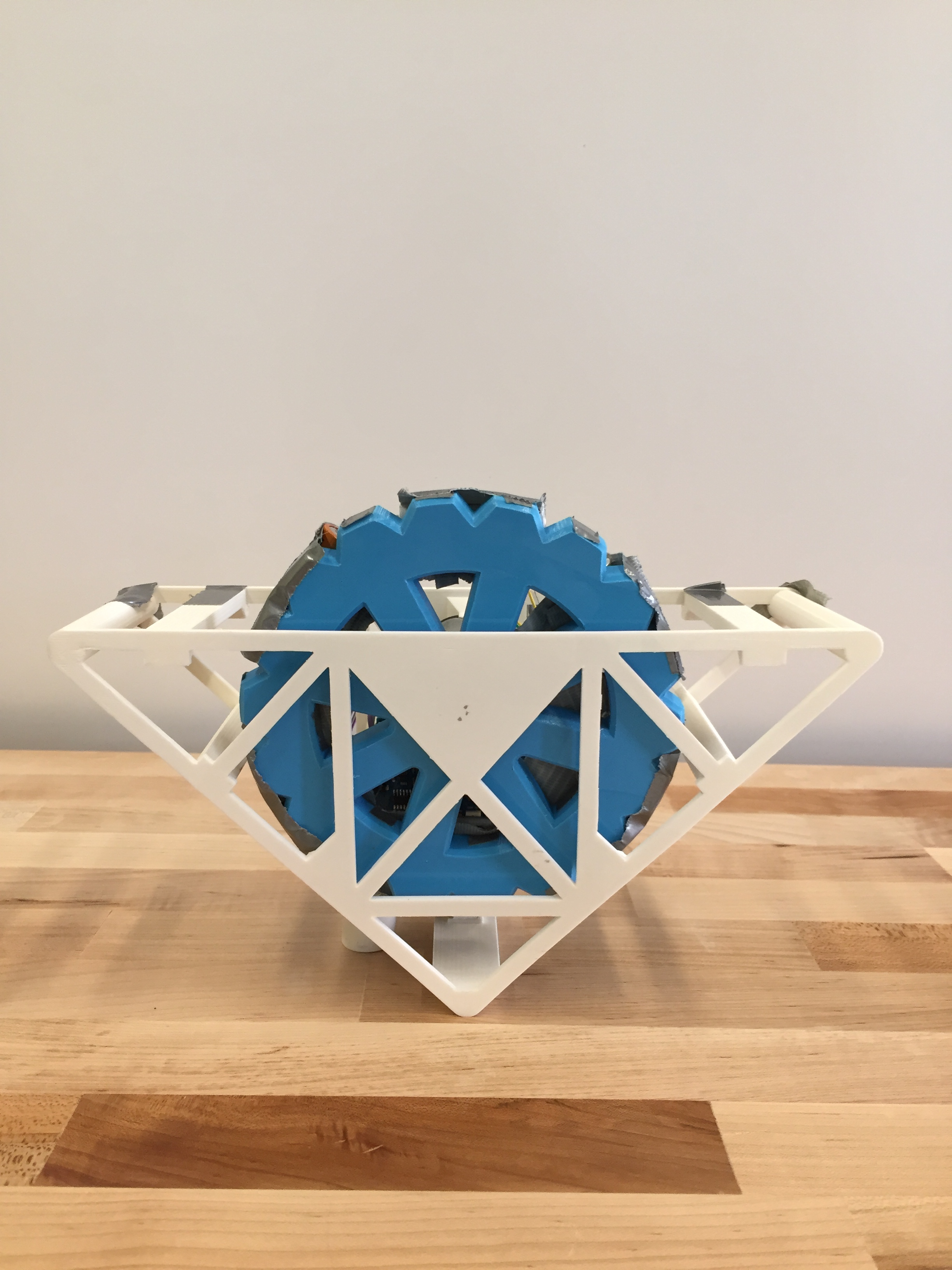 Inverted pendulum V3 with white frame and blue reaction wheel, front view